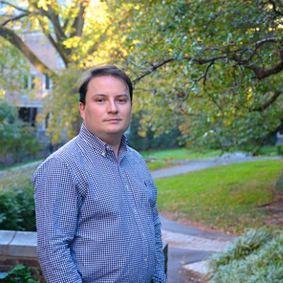 A man in a blue shirt in a garden